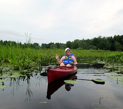 Lin Gibbs kayaking on the river