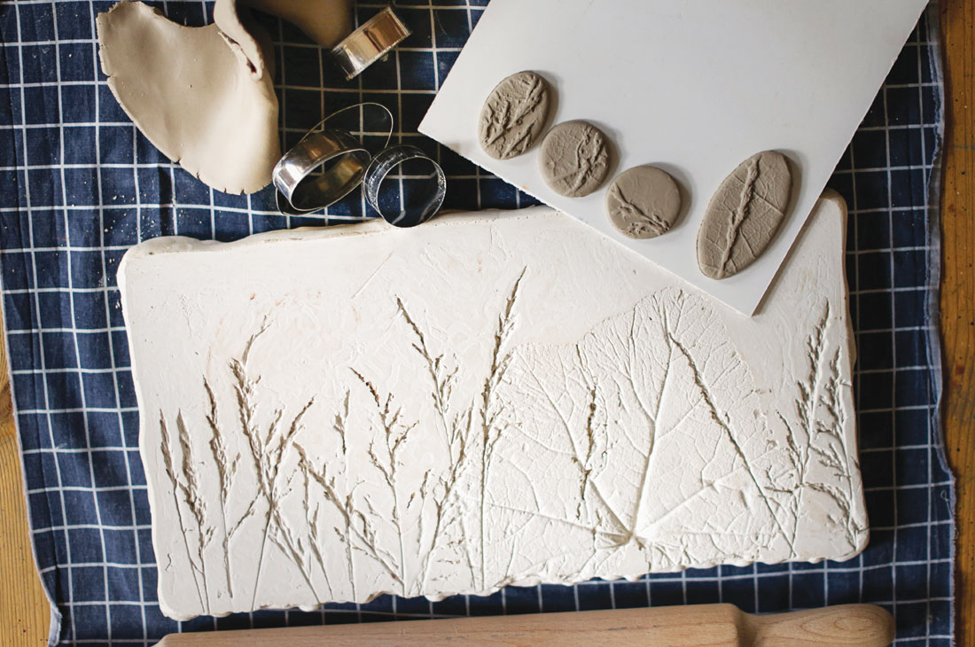 rolling out dough or clay to press leaves, sticks and natural items into